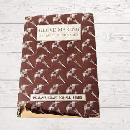 Book titled 'Glove Making' by Isabel M. Edwards on a wooden surface