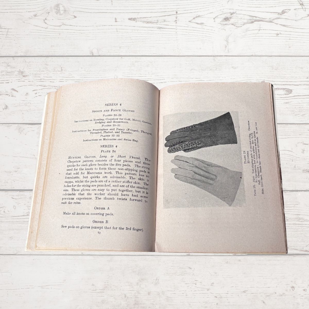 Open book with illustrations of gloves on a wooden surface