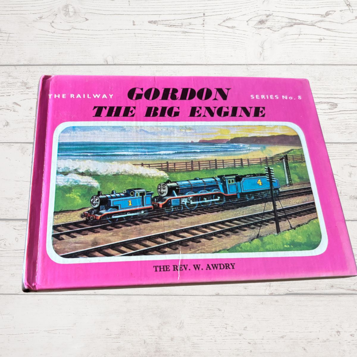 Book titled 'Gordon the Big Engine' by W. Awdry on a wooden surface