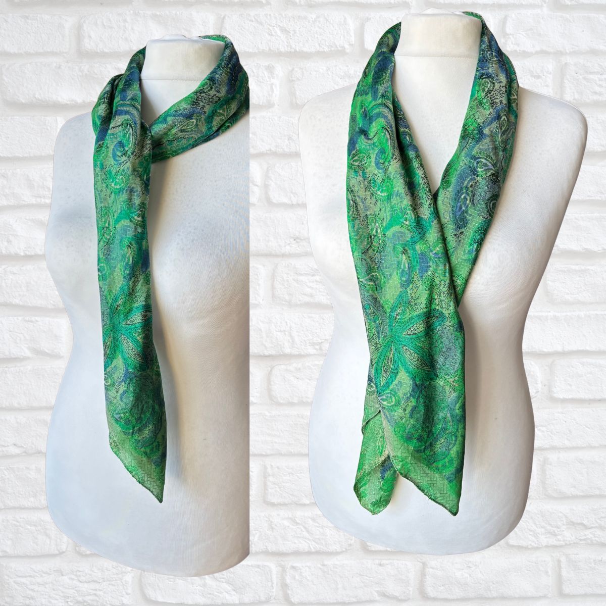 Green patterned scarf on a mannequin against a white brick wall.