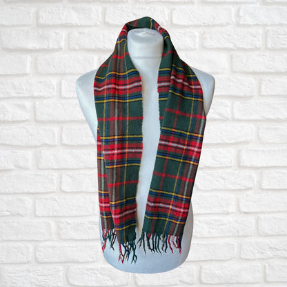 Plaid scarf on a mannequin against a white brick wall background