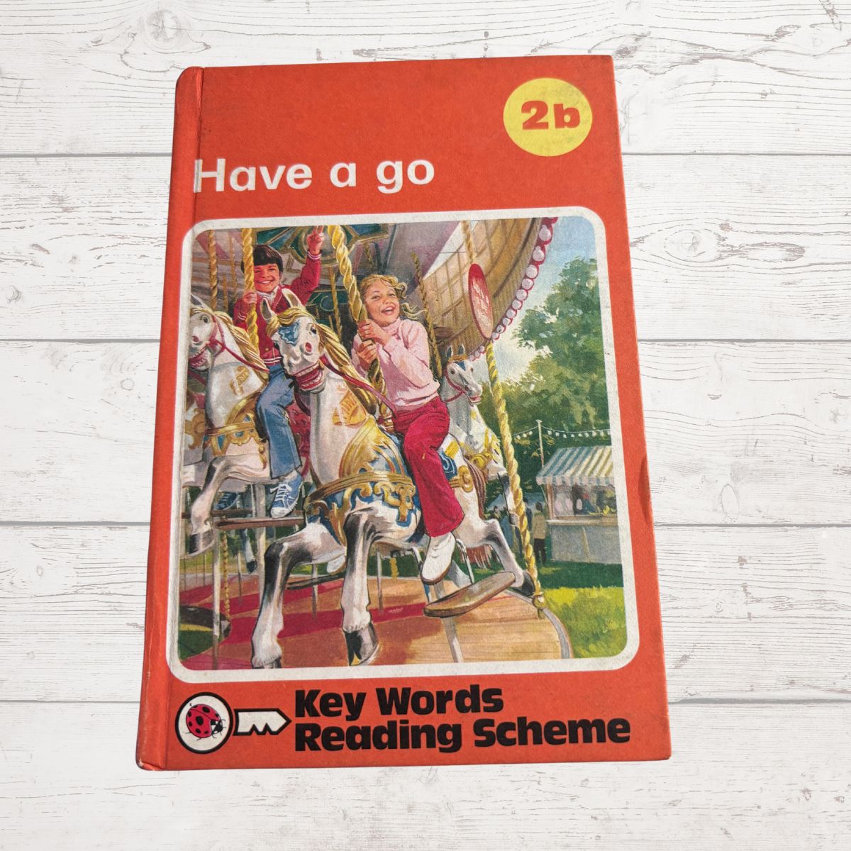 Book cover of 'Have a go' from Key Words Reading Scheme on a wooden surface