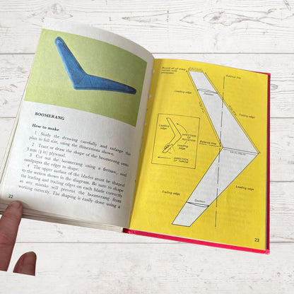 Open book with instructions on making a boomerang, showing diagrams and text.