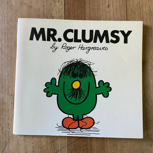 A small white vintage book. Mr Clumsy by Roger Hargreaves. Cover features a green character with messy hair and an untidy moustache 