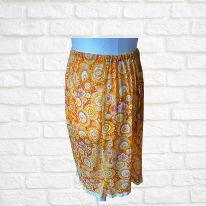 70s yellow and orange psychedelic print waist slip/ skirt. Approx U.K. size 14-20