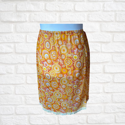 70s yellow and orange psychedelic print waist slip/ skirt. Approx U.K. size 14-20