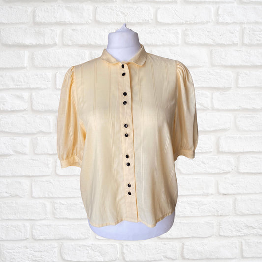 Yellow 80s blouse with black buttons and puffed short sleeves. Approx  U .K. size  14-18