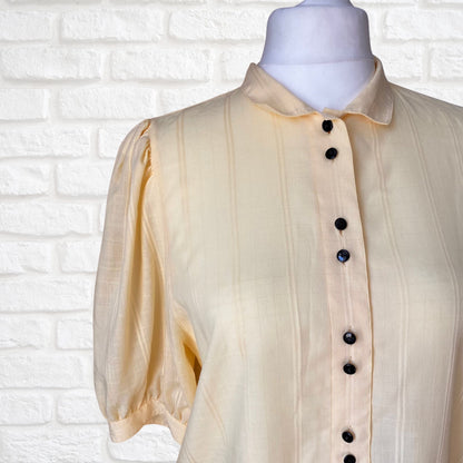 Yellow 80s blouse with black buttons and puffed short sleeves. Approx  U .K. size  14-18