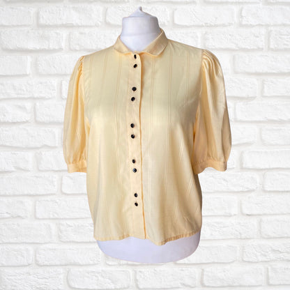 Yellow 80s blouse with black buttons and puffed short sleeves. Approx  U .K. size  14-18