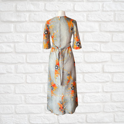 70s Hawaiian vintage maxi dress in an orange floral print.  Approx U.K. size 4-6