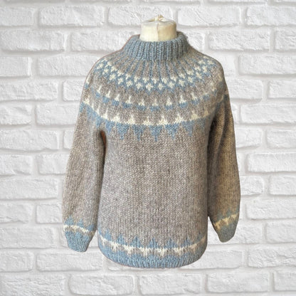 Knitted sweater with a pattern on a white brick wall background
