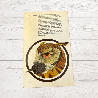 A vintage illustrated book or booklet cover featuring a large owl illustration with text at the top, photographed on a whitewashed wooden surface.