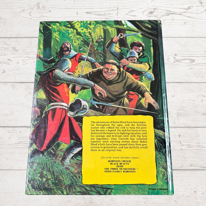 Book cover with an illustration of Robin Hood and his merry men in a forest setting.