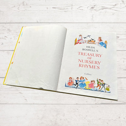 Book titled 'Hilda Boswell's Treasury of Nursery Rhymes' on a wooden surface