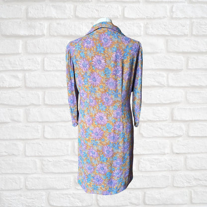 Floral dress on a mannequin against a white brick wall background