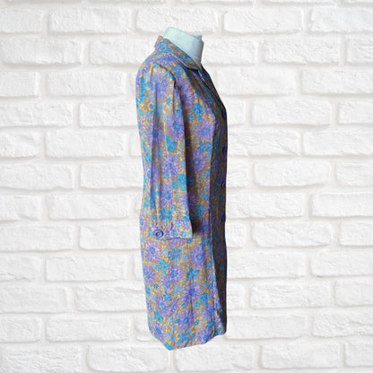 Floral-patterned dress on a mannequin against a white brick wall background