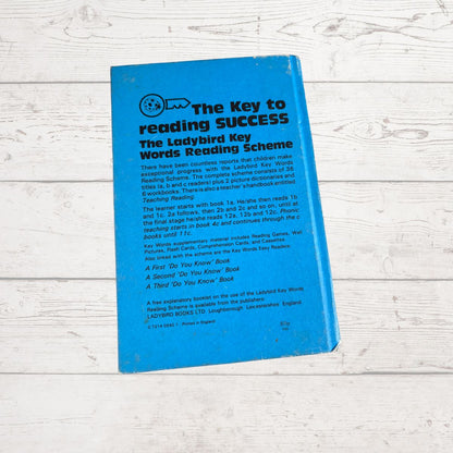 Blue book titled 'The Key to Reading Success' on a wooden surface