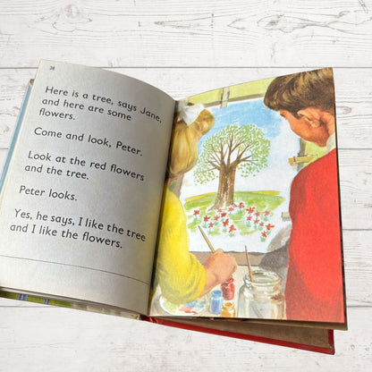 Open book with illustrations and text on a wooden surface