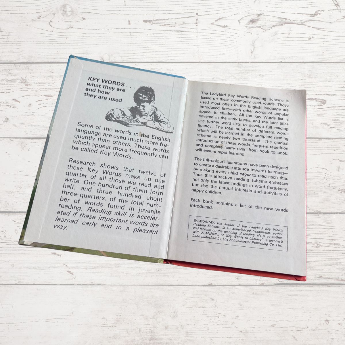 Open book on a wooden surface with text and illustrations