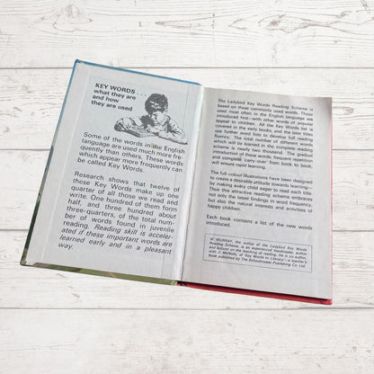 Open book on a wooden surface with text and illustrations