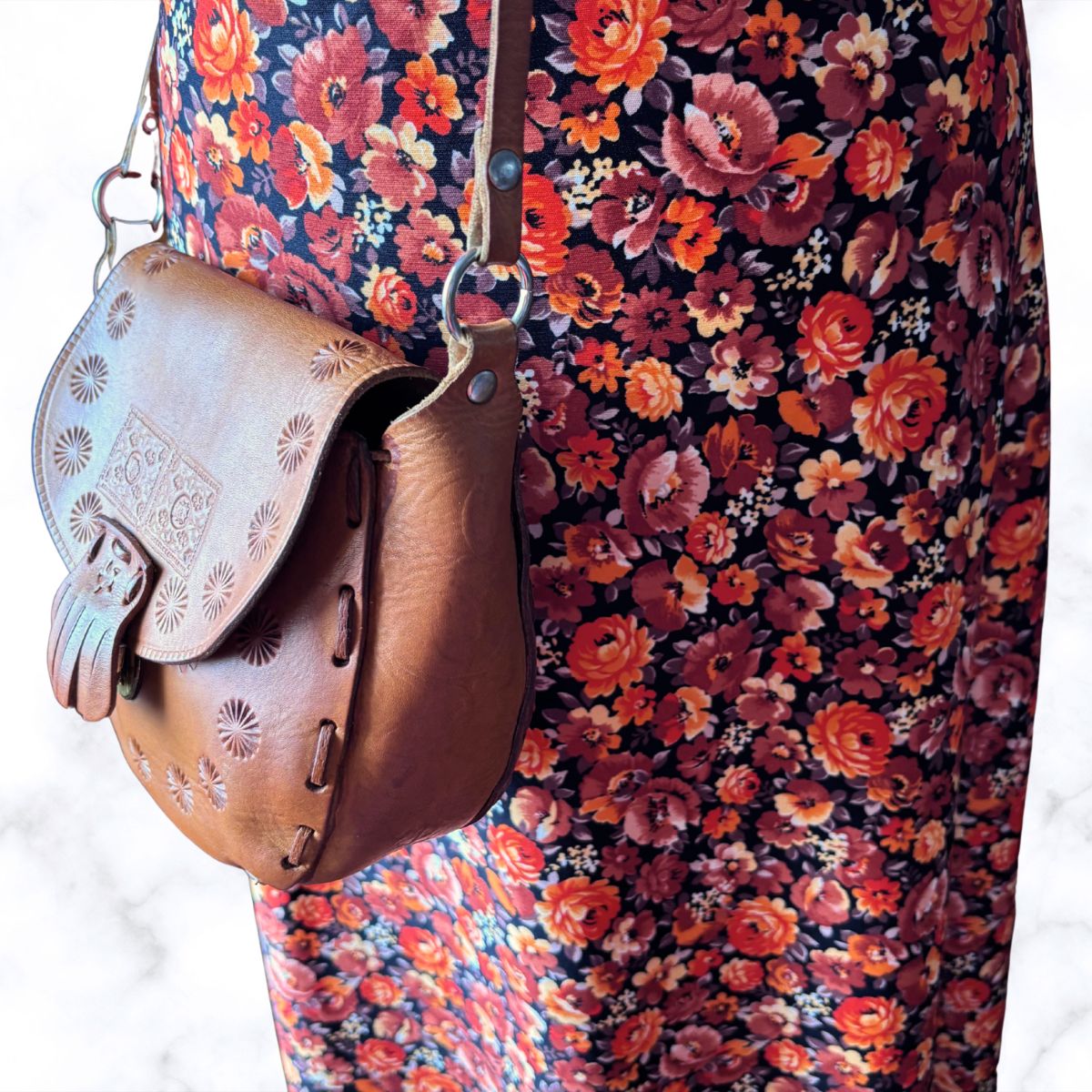 Decorated leather cross body festival bag on a floral dress