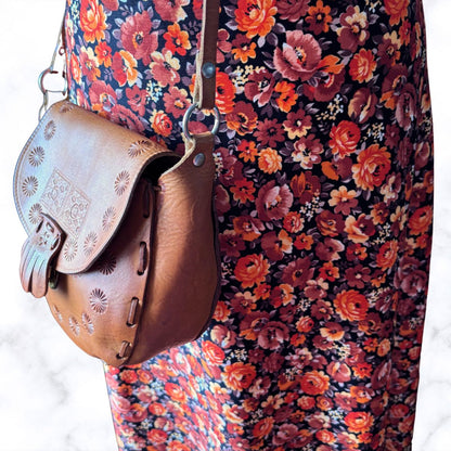 Decorated leather cross body festival bag on a floral dress