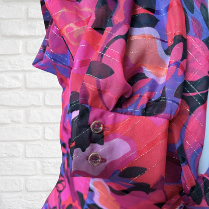 Colorful patterned fabric with a white brick wall background