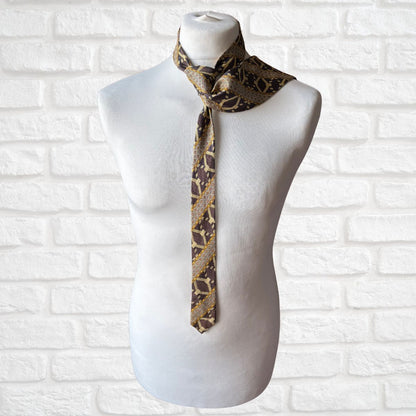 Mannequin wearing a patterned tie against a white brick wall background