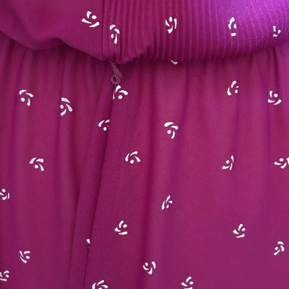 Close-up of a purple fabric with white floral patterns