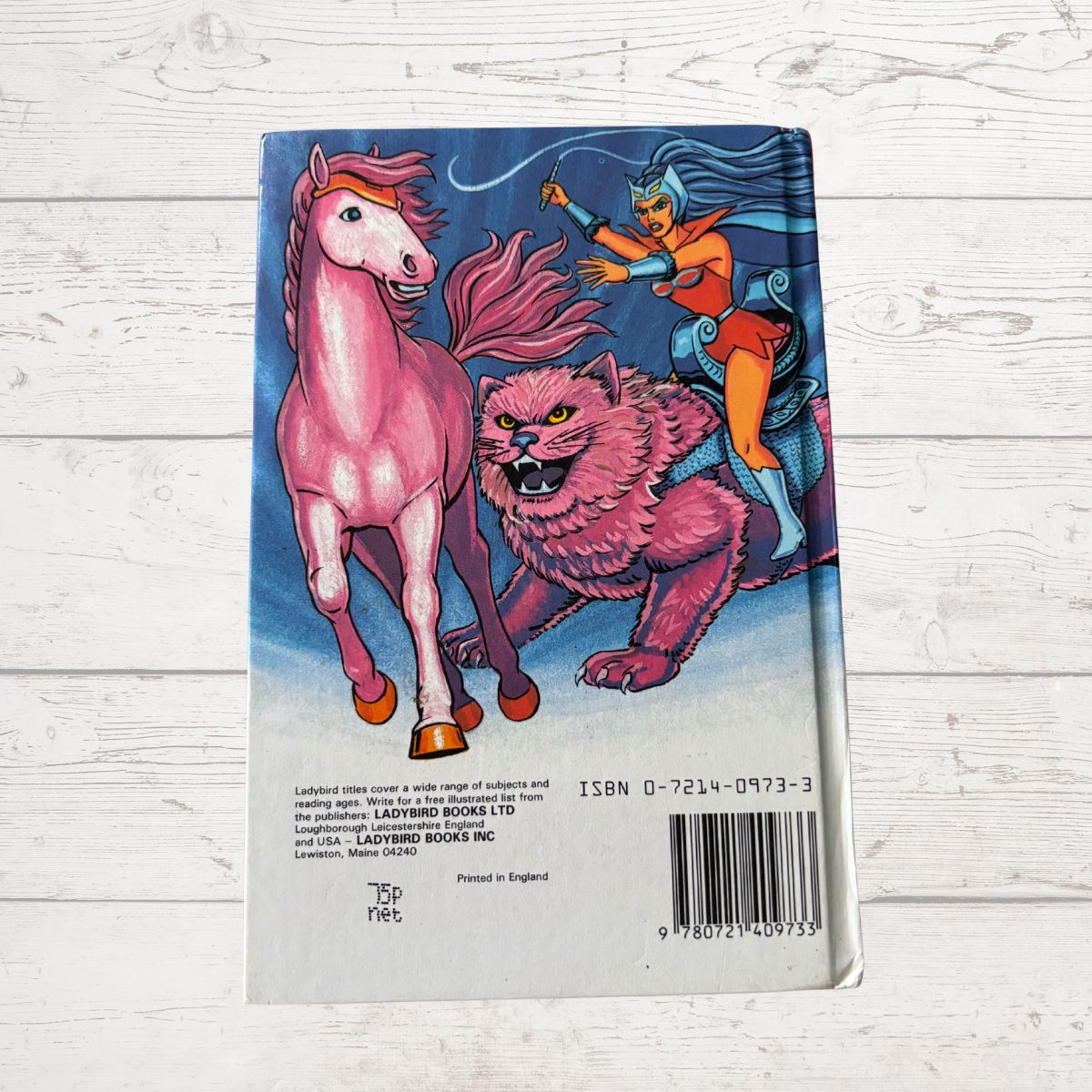 Book cover with fantasy illustration of a horse and creature on a light wooden surface