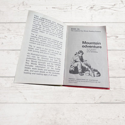 Open book titled 'Mountain Adventure' on a wooden surface