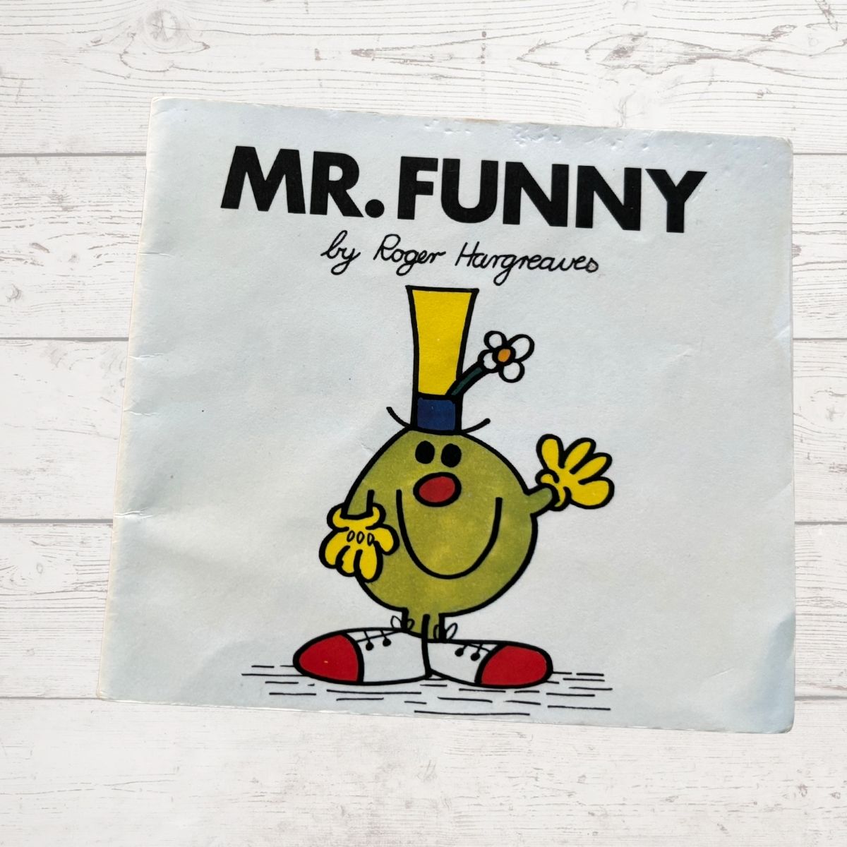 Book cover of 'Mr. Funny' by Roger Hargreaves on a light wooden surface.