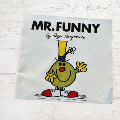 Book cover of 'Mr. Funny' by Roger Hargreaves on a light wooden surface.