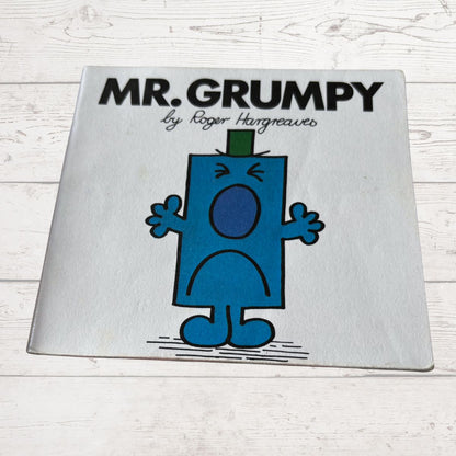 Book titled 'Mr. Grumpy' by Roger Hargreaves on a wooden surface