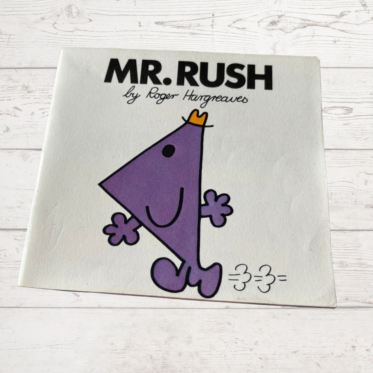 Book cover of 'Mr. Rush' by Roger Hargreaves on a white wooden surface