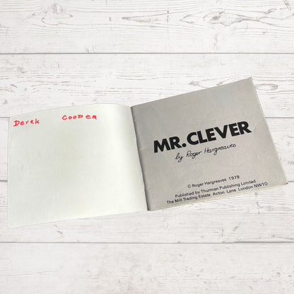Open book with 'MR. CLEVER' by Roger Hargreaves on a light wooden surface