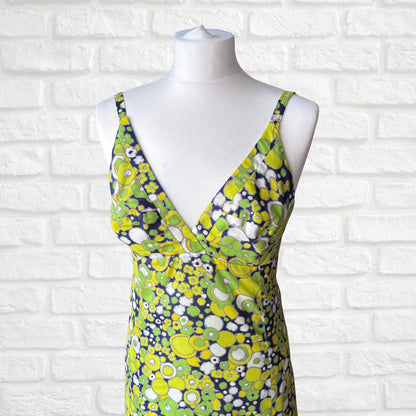 Floral dress on a mannequin against a white brick wall background