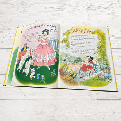 Open book with illustrated pages on a wooden surface