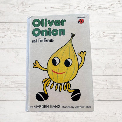 Book titled 'Oliver Onion and Tim Tomato' with a cartoon onion character on a light wooden background