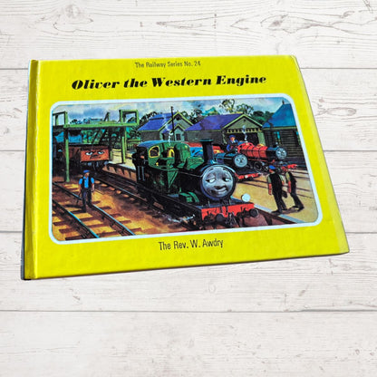 Book titled 'Oliver the Western Engine' on a wooden surface