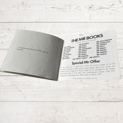 Open book with text on a light wooden surface