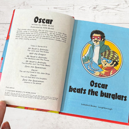 Open book showing a page from 'Oscar beats the burglars' by Ladybird Books.