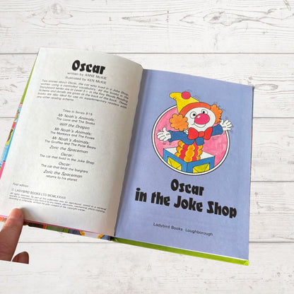 Open book showing a page with a clown illustration and text on a wooden surface