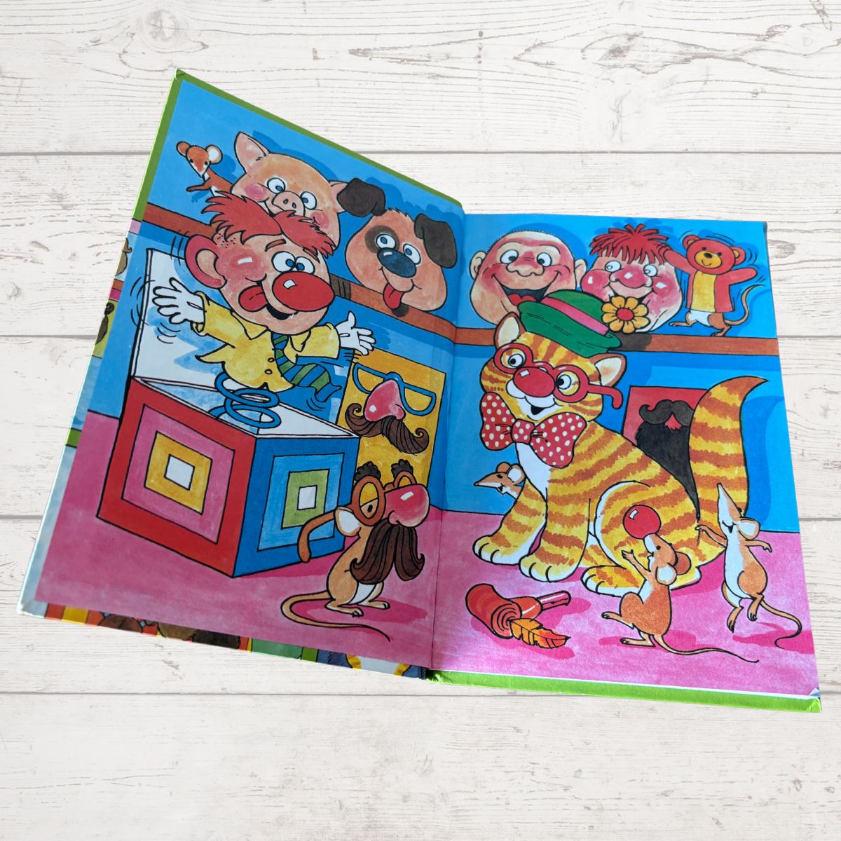 Oscar the cat that lived in the joke shop. Colourful inside cover on a white background 