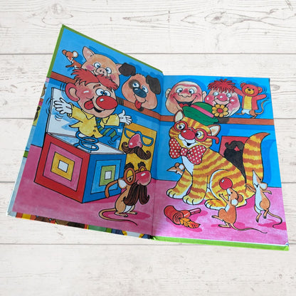 Oscar the cat that lived in the joke shop. Colourful inside cover on a white background 