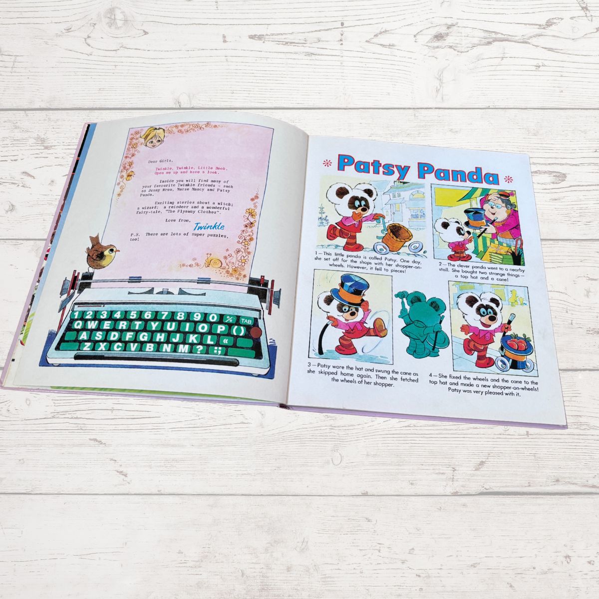 An open children's book laid flat on a white wood surface, showing printed pages with a typewriter illustration and cartoon panels titled 'Patsy Panda.'.