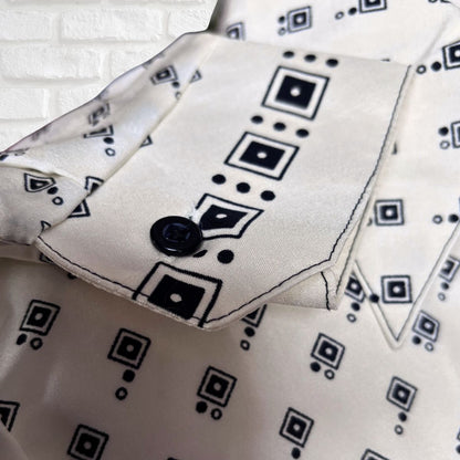 Cream and black geometric print 70s shirt cuffs on a white background 