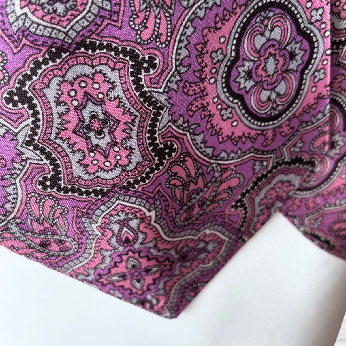 Close-up of a pink and black paisley patterned fabric.