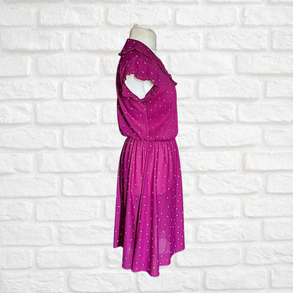 Purple dress on a mannequin against a white brick wall background