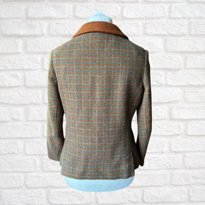 Plaid blazer on a mannequin against a white brick wall background